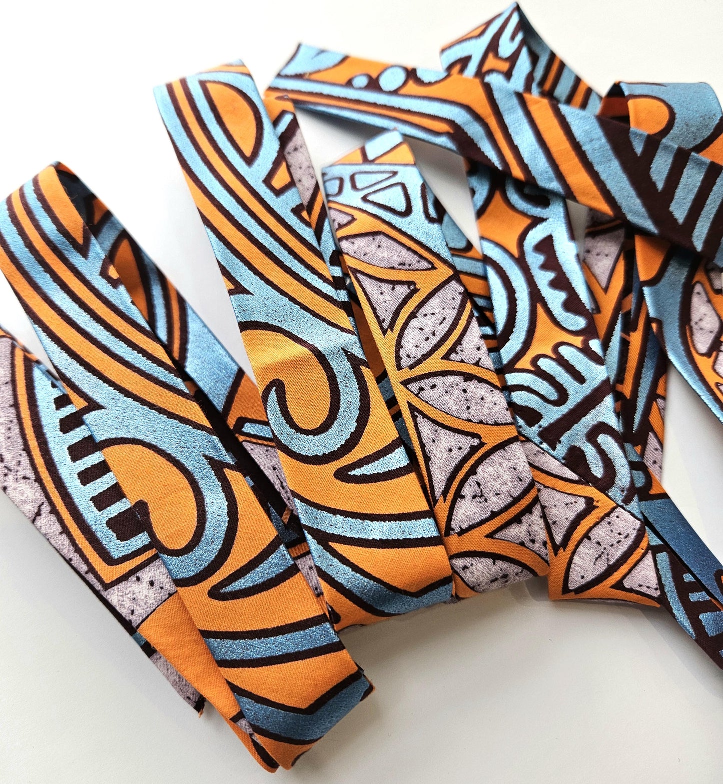 Set Of 3 African Wax Geometric Metallic Fabric Bias Binding. 5 Metres Each x  2.5cm Wide in Pink, Orange & Blue For Crafting And Quilting.